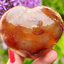 Heart made of carnelian stone in the palm of 6.1 cm