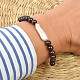 Garnet and mother of pearl bracelet on his hand