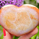 Smooth carnelian heart in the palm of 6.4 cm